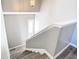 Bright foyer staircase with wood-look flooring and a view of the front door at 6021 Windhover Dr # F11, Orlando, FL 32819
