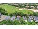 Aerial view of home with a pool, golf course, mature trees, and lush landscaping at 6037 Caymus Loop, Windermere, FL 34786