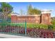 Entrance to Keene's Pointe featuring brick pillars, wrought iron gates, and beautiful landscaping at 6037 Caymus Loop, Windermere, FL 34786