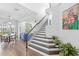 Bright entryway with wood floors, staircase, and views into the living and dining area at 6037 Caymus Loop, Windermere, FL 34786
