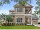 Stunning two-story home featuring a charming front porch and manicured lawn at 6037 Caymus Loop, Windermere, FL 34786