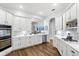 Bright, white kitchen with modern appliances, countertops, and hardwood flooring at 6037 Caymus Loop, Windermere, FL 34786