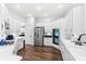 Spacious kitchen with stainless steel appliances and white cabinetry with an open floorplan at 6037 Caymus Loop, Windermere, FL 34786