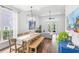Bright, open living room featuring a large dining table and view to outside at 6037 Caymus Loop, Windermere, FL 34786
