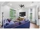 Bright living room featuring a large window, dark hardwood floors, and a ceiling fan at 6037 Caymus Loop, Windermere, FL 34786