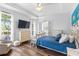 Bright main bedroom with tray ceiling, two windows and outside view at 6037 Caymus Loop, Windermere, FL 34786