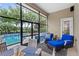 Screened patio features outdoor dining and seating near the pool at 6037 Caymus Loop, Windermere, FL 34786
