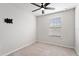 Cozy bedroom with ceiling fan, one window, and a wall-mounted TV bracket at 6165 Juneberry Way, Winter Garden, FL 34787