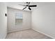 Neutral bedroom with a ceiling fan, carpeted floor, and a window letting in natural light at 6165 Juneberry Way, Winter Garden, FL 34787