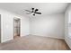 Large bedroom featuring neutral carpet, a ceiling fan, and a walk-in closet at 6165 Juneberry Way, Winter Garden, FL 34787