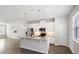 A stylish kitchen featuring stainless steel appliances, stone countertops, an island, and ample cabinet space at 6165 Juneberry Way, Winter Garden, FL 34787