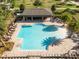 Aerial view of a community pool with palm trees, seating, and a covered pavilion at 6165 Juneberry Way, Winter Garden, FL 34787
