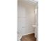 Well-lit powder room featuring a pedestal sink, towel rack, and wood-look flooring at 6165 Juneberry Way, Winter Garden, FL 34787