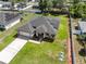 Beautiful aerial view showcasing home with solar panels and long driveway at 675 S Cedar Ave, Orange City, FL 32763