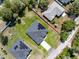 A beautiful aerial view shows the house with solar panels and a long driveway at 675 S Cedar Ave, Orange City, FL 32763