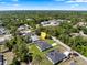 An aerial view of a neighborhood showcases the home amongst lush greenery and nearby residences at 675 S Cedar Ave, Orange City, FL 32763