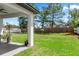 Expansive backyard with lush green grass, mature trees, and a privacy fence at 675 S Cedar Ave, Orange City, FL 32763
