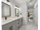 Elegant bathroom vanity with double sinks, gray cabinets, quartz counters, and modern fixtures at 675 S Cedar Ave, Orange City, FL 32763
