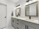 Contemporary bathroom featuring double sinks, gray cabinets, modern fixtures, and ample counter space at 675 S Cedar Ave, Orange City, FL 32763