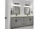 Elegant bathroom vanity with double sinks, gray cabinets, quartz counters, and modern fixtures at 675 S Cedar Ave, Orange City, FL 32763