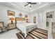Comfortable bedroom with a neutral color scheme, decorative wall hangings, and ceiling fan for a cozy feel at 675 S Cedar Ave, Orange City, FL 32763