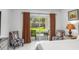 Bright bedroom offering sliding glass door with patio access, neutral decor, and comfortable seating at 675 S Cedar Ave, Orange City, FL 32763