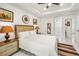 Comfortable bedroom with a neutral color scheme, decorative wall hangings, and ceiling fan for a cozy feel at 675 S Cedar Ave, Orange City, FL 32763