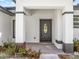 Inviting covered entrance with a charming front door and meticulous landscaping at 675 S Cedar Ave, Orange City, FL 32763