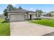 Charming single-story home featuring a well-manicured lawn, tidy landscaping, and a wide driveway at 675 S Cedar Ave, Orange City, FL 32763