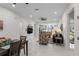 Bright living room open to kitchen area features neutral walls, marble floors, and comfortable seating at 675 S Cedar Ave, Orange City, FL 32763