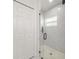 Modern bathroom shower with white marble tile, glass door, and hexagon tile floor at 675 S Cedar Ave, Orange City, FL 32763