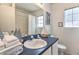Bright bathroom featuring a sink with modern fixtures and a framed mirror at 730 Bloomingdale Dr, Davenport, FL 33897