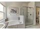 Bathroom featuring a shower with a glass door, bathtub, and natural light at 730 Bloomingdale Dr, Davenport, FL 33897
