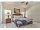 Cozy bedroom with a large window, ceiling fan and tasteful decor at 730 Bloomingdale Dr, Davenport, FL 33897