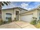 Charming home featuring an attached two car garage and well-maintained landscaping at 730 Bloomingdale Dr, Davenport, FL 33897