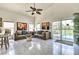 Inviting living area featuring neutral tones, marble floors and access to the pool area at 730 Bloomingdale Dr, Davenport, FL 33897