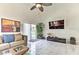 Bright living room with high ceilings, decorative art, a plush sofa, and a large tv at 730 Bloomingdale Dr, Davenport, FL 33897