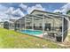 This backyard features a screened-in pool and patio for relaxation and outdoor enjoyment at 730 Bloomingdale Dr, Davenport, FL 33897