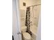 A compact bathroom features a toilet and shower-tub with a patterned shower curtain at 7900 S Orange Blossom Trl # 2025, Orlando, FL 32809