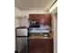 Functional kitchenette equipped with modern microwave and mini-fridge at 7900 S Orange Blossom Trl # 2025, Orlando, FL 32809