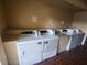 A shared laundry area with coin-operated washing machines and tiled flooring at 7900 S Orange Blossom Trl # 2025, Orlando, FL 32809