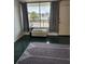 An open living space with tiled floors, a window AC, and a neutral area rug at 7900 S Orange Blossom Trl # 2025, Orlando, FL 32809