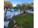 An elevated view of a community pool with palm trees, fencing, and well-maintained landscaping at 7900 S Orange Blossom Trl # 2025, Orlando, FL 32809