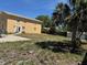 Exterior view of building showing the backyard and fence with patio and sparse grass at 8 E Summit St, Apopka, FL 32712