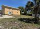 Exterior view of building showing the backyard and fence with patio and sparse grass at 8 E Summit St, Apopka, FL 32712
