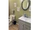 Bathroom view featuring vanity and sink, toilet, and framed art hanging on the wall at 8 E Summit St, Apopka, FL 32712