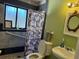Bathroom with accessible features, tiled shower, and decorative mirror over a sink at 8 E Summit St, Apopka, FL 32712