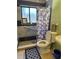 Bathroom with accessible features, tiled shower, and decorative mirror over a sink at 8 E Summit St, Apopka, FL 32712