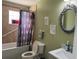 Standard bathroom with tile shower, decorated with unique art and a charming mirror at 8 E Summit St, Apopka, FL 32712