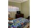 Bedroom featuring colorful Mario-themed bedding, natural light, and dark dresser at 8 E Summit St, Apopka, FL 32712